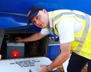 Pilot Wim Hobo loads vaccine on a MAF plane