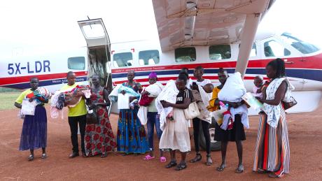 Babies with hydrocephalus and their carers at Tororo Airstrip