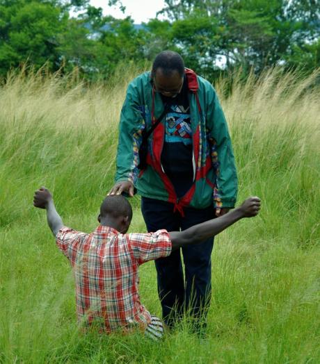 Evangelist praying over local