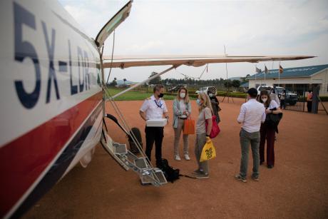 Pilot Pieter Room helping unload passengers in Mbarara