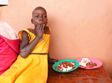 A pupil enjoys lunch at school