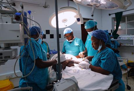 A team of Cure Hospital doctors performs surgery on a baby