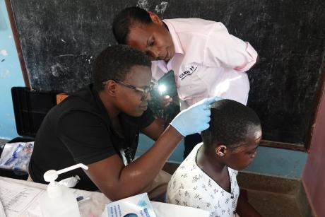 Cure Hospital doctors review a patient the Mbarara medical camp